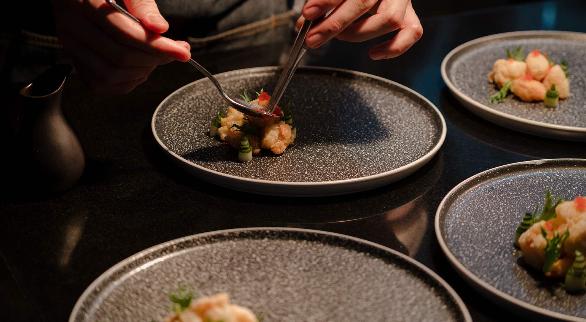 Your private chef carefully arranging food on plates, demonstrating attention to detail in meal presentation.