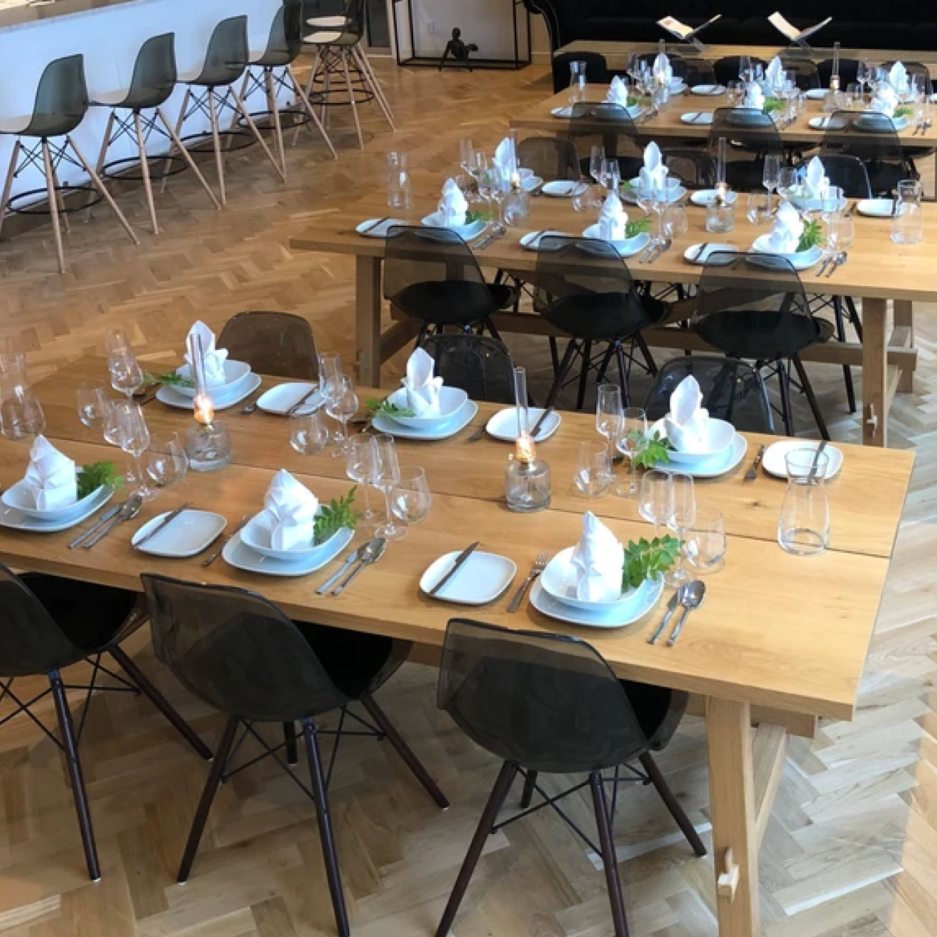 Multiple tables set with place settings and chairs in the SBC Lodge restaurant.